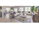Bright living room with large windows, tile flooring, and an open layout at 1027 Gentle Swan St # 689, Henderson, NV 89011