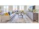 Bright living room with modern furnishings, neutral walls, ample natural light, and wood-look floors at 1027 Gentle Swan St # 689, Henderson, NV 89011
