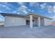 Rear view of a home featuring a covered patio area and neutral colored walls at 1131 Lupin St, Pahrump, NV 89048