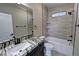 Beautiful bathroom featuring a tiled shower/tub, a granite countertop, and modern fixtures at 1131 Lupin St, Pahrump, NV 89048