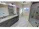 Bathroom has a stylish vanity with double sinks, large mirror, and glass-enclosed shower at 1131 Lupin St, Pahrump, NV 89048