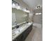 Bathroom with dual sink vanity, large mirror, and shower/tub combo at 1131 Lupin St, Pahrump, NV 89048