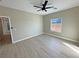 Bright bedroom with wood-look floors, neutral paint, and a window view of mountains in the distance at 1131 Lupin St, Pahrump, NV 89048