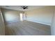 Open bedroom showcases light wood flooring, fan, and neutral walls at 1131 Lupin St, Pahrump, NV 89048