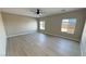 Spacious bedroom features contemporary ceiling fan, light-colored wood floors and bright windows at 1131 Lupin St, Pahrump, NV 89048