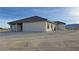 The right side exterior of the house has multiple dark framed windows and a grey stucco finish at 1131 Lupin St, Pahrump, NV 89048