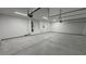 Empty three car garage with overhead door mechanisms at 1131 Lupin St, Pahrump, NV 89048