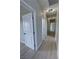 Hallway with hardwood floors and multiple doors and recessed lighting at 1131 Lupin St, Pahrump, NV 89048
