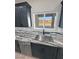 Stainless steel sink and granite counters in a modern kitchen, providing form and function at 1131 Lupin St, Pahrump, NV 89048
