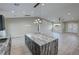 Kitchen island with marble counters, wood cabinets, and pendant lighting at 1131 Lupin St, Pahrump, NV 89048