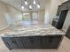Spacious kitchen features a large island with elegant countertops, stainless steel appliances and dark wood cabinets at 1131 Lupin St, Pahrump, NV 89048