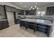 A spacious kitchen features stainless steel appliances, ample dark wood cabinetry, and a large central island at 1131 Lupin St, Pahrump, NV 89048