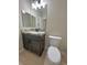 Stylish powder room featuring a modern vanity, granite countertop, and elegant lighting at 1131 Lupin St, Pahrump, NV 89048