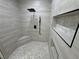 Elegant shower featuring modern fixtures, built-in niche shelving, and gray mosaic tile flooring at 1131 Lupin St, Pahrump, NV 89048