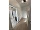 Bright walk-in closet with white shelves, rod, and wood-look flooring at 1131 Lupin St, Pahrump, NV 89048