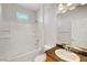 Bright bathroom with a white tiled tub and shower combination, along with a granite countertop vanity at 11356 Belmont Lake Dr # 103, Las Vegas, NV 89135