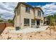 View of backyard with patio, two-story house and drought tolerant landscaping at 11769 Via Vera Cruz Ct, Las Vegas, NV 89138