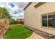 View of side yard with artificial turf and partial privacy fence at 11769 Via Vera Cruz Ct, Las Vegas, NV 89138