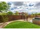 Landscaped backyard features artificial turf, brick wall, and wrought iron fence at 11769 Via Vera Cruz Ct, Las Vegas, NV 89138