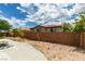 Backyard featuring a concrete patio, privacy wall, and drought-tolerant landscaping at 11769 Via Vera Cruz Ct, Las Vegas, NV 89138