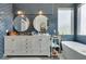 Stylish bathroom with double vanity, soaking tub, and chic blue tile at 11769 Via Vera Cruz Ct, Las Vegas, NV 89138