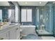 Elegant bathroom with freestanding tub, glass shower, and patterned tile at 11769 Via Vera Cruz Ct, Las Vegas, NV 89138