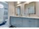 Stylish bathroom featuring double sinks, attractive vanity, framed mirrors, and patterned tile floors at 11769 Via Vera Cruz Ct, Las Vegas, NV 89138