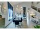 A formal dining room with high ceilings, gray walls, modern chandelier and beautiful hardwood floors at 11769 Via Vera Cruz Ct, Las Vegas, NV 89138