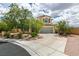 Inviting two-story home with a well-maintained yard and spacious driveway with landscaping at 11769 Via Vera Cruz Ct, Las Vegas, NV 89138