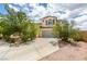 Charming two-story home with a well-manicured yard, mature trees, and a spacious driveway at 11769 Via Vera Cruz Ct, Las Vegas, NV 89138