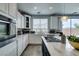 Modern kitchen featuring white countertops and cabinets, stainless steel appliances, and an island gas stovetop at 11769 Via Vera Cruz Ct, Las Vegas, NV 89138