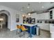 Stylish kitchen with a contrasting blue island, pendant lights, and modern appliances for culinary enthusiasts at 11769 Via Vera Cruz Ct, Las Vegas, NV 89138