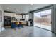 Bright kitchen with stainless appliances, blue island with bar seating, and sliding glass doors at 11769 Via Vera Cruz Ct, Las Vegas, NV 89138