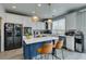 Bright kitchen featuring a blue island, white cabinets, and modern appliances, perfect for cooking and entertaining at 11769 Via Vera Cruz Ct, Las Vegas, NV 89138