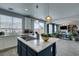 Stylish kitchen with an island gas stovetop, offering ample space, stainless steel appliances, and a view of the living room at 11769 Via Vera Cruz Ct, Las Vegas, NV 89138
