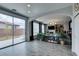Open-concept living room with sliding glass door and view of the backyard at 11769 Via Vera Cruz Ct, Las Vegas, NV 89138