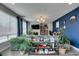 Inviting living room featuring a dark blue accent wall and view of fireplace and shelves at 11769 Via Vera Cruz Ct, Las Vegas, NV 89138
