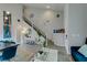 The home features an open floorplan, hardwood floors, gray walls and lots of natural light from the large windows at 11769 Via Vera Cruz Ct, Las Vegas, NV 89138