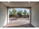 Covered patio with brick pavers looks out over the manicured backyard at 11843 Cogoleto Ave, Las Vegas, NV 89138