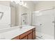 Bathroom featuring a double shower, wood cabinets, and a white countertop sink at 11843 Cogoleto Ave, Las Vegas, NV 89138