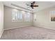 Spacious bedroom featuring neutral carpet, ceiling fan, recessed lighting, and shuttered windows at 11843 Cogoleto Ave, Las Vegas, NV 89138