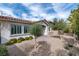 Beautifully landscaped front yard with mature trees and a charming brick walkway at 11843 Cogoleto Ave, Las Vegas, NV 89138