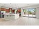 Beautiful kitchen area with stainless steel appliances, a large island and sliding glass doors at 11843 Cogoleto Ave, Las Vegas, NV 89138