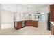 Spacious kitchen with a large island, stainless steel appliances, and dark wood cabinets at 11843 Cogoleto Ave, Las Vegas, NV 89138