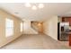 Open-concept living room showcasing neutral carpeting and paint, staircase access and natural light at 11943 Jersey Lilly St, Las Vegas, NV 89183