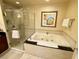 Bright bathroom features a large soaking tub with shower and modern fixtures at 125 E Harmon Ave # 1003, Las Vegas, NV 89109