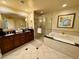 Spacious bathroom with double sinks, a soaking tub, and a separate glass-enclosed shower at 125 E Harmon Ave # 1003, Las Vegas, NV 89109