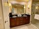 Elegant bathroom with a double vanity, ample lighting, and a glass-enclosed shower for a spa-like experience at 125 E Harmon Ave # 1003, Las Vegas, NV 89109