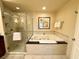 Bright bathroom features a large soaking tub with shower and modern fixtures at 125 E Harmon Ave # 1003, Las Vegas, NV 89109