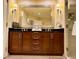 Luxurious bathroom featuring double sinks, a large mirror, and a glass-enclosed shower for a modern touch at 125 E Harmon Ave # 1003, Las Vegas, NV 89109